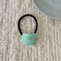 Detail of light green arc resin hair tie with France Handmade text on knit background - Mint Green