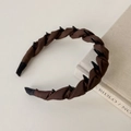 Close-up of twisted brown satin headband with anti-slip teeth and fabric texture - Brown