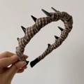 Detailed view of coffee plaid fabric headband with black shark teeth grip design - Khaki