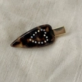 Detail of tortoise shell heart hair clip with sparkling rhinestones and gold metal base - Tortoiseshell