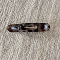 Macro detail of tortoiseshell leopard hair claw clip on beige textured fabric - Grey Tortoiseshell Duckbill Clip