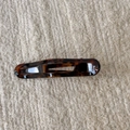 Detail of tortoise shell hair clip with glossy acetate texture on knit background - Coffee Tortoiseshell Duckbill Clip