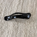 Detail of sleek black glossy hair claw clip with non-slip teeth on textured fabric - Black Duckbill Clip