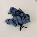 Detailed view of dark blue polka dot fabric banana clip with non-slip plastic comb teeth - Banana Clip / Blue
