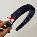 Detailed macro view of navy blue polka dot headband with handmade bow and sponge padding - Polka Dot Headband