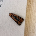 Triangle leopard print hair clip with black stitched edges on soft fabric background - Dark Hollow Small Triangle