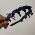 Detail of navy blue plaid headband featuring a red ribbon bow and blue button detail - Blue Denim Tooth Comb Headband