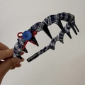 Detailed view of navy blue plaid headband with red ribbon bows and blue button accents - Plaid Tooth Comb Headband