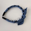 Detailed macro view of the non-slip hair comb teeth and blue polka dot fabric texture - Headband / Blue