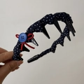 Detailed view of navy blue polka dot headband with red velvet bow and anti-slip teeth - Polka Dot Tooth Comb Headband