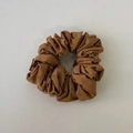 Close-up of caramel brown scrunchie with dense pleated cotton fabric texture - Orange Coffee Hair Tie
