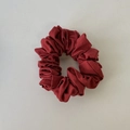 Detailed view of the dark red ribbed fabric texture on the retro hair scrunchie - Red Hair Tie