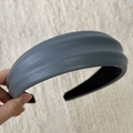 Detail of matte blue-gray PU leather headband with thick folds and grainy texture - Gray
