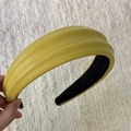 Detail of yellow faux leather padded headband with visible texture and non-slip lining - Yellow