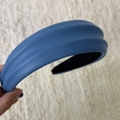 Detailed view of sky blue PU leather headband with thick padded ribbed design and matte lining - Blue