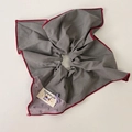 Detail of grey floral scrunchie with red contrast edging and 'Dynamic Life' woven label - Grey Paisley Bandana