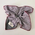 Detail of floral scrunchie with lavender print, purple bow, and Dynamic Life woven tag - Purple Scarf Tie
