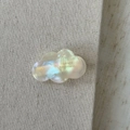 Detailed macro view of pearlescent acetate cloud hair clip with golden handmade logo - Mermaid White