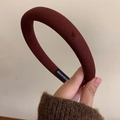 Detail showing the burgundy padded headband fabric texture and handmade label - Red