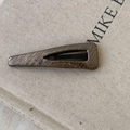 Detail of faux leather teardrop hair clip with snakeskin texture and bronze finish - Champagne Gray Slim Triangle Style