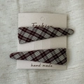 Detail view of two vintage plaid fabric hair clips in burgundy and green on a textured background - Pair Clip / Dark Red Plaid