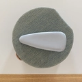 Detailed view of light gray glossy patent leather hair clip on denim textured base - Blue