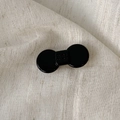 Glossy black acetate hair clip with war war engraving on a white linen background - Bowknot Style / Small / Black