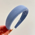 Detail shot of light blue padded headband with white bow print and fabric texture - Dark Blue