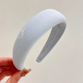 Detail view showing thick light blue fabric headband with white bow embroidery texture - Light Blue