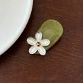 Dettaglio del fermaglio per capelli in acetato verde oliva con fiore bianco e strass ambra - Fiore Bianco Base Verde