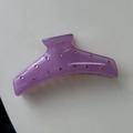 Detailed close-up of lavender translucent hair claw clip with embedded white rhinestones - Purple