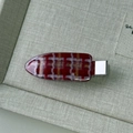 Detail of red and white checkered hair clip with gold glitter in a display box - Red