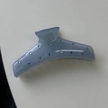 Detailed close-up of blue moon-shaped hair claw clip with rhinestones and metal spring - Blue