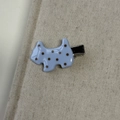 Close-up of a blue Scottish Terrier hair clip with brown polka dots on linen fabric - Blue Dog Hair Clip
