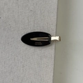 Detail of oval acetate hair clip with golden France Handmade logo and duckbill clip - Black