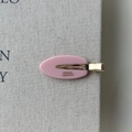 Close-up of pink oval acetate hair clip with golden France Handmade engraving details - Pink