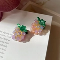 Detailed macro view of purple grape acetate hair clip with golden trim and green leaves - Grapes