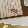 Brown acetate hair clip with gold star pattern and pink rhinestones in a jewelry box - Bean Paste Star