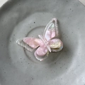 Macro shot of French acetate butterfly hair clip with pink pearlescent marble texture - Mermaid Pink