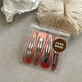 Set of four gradient red resin BB hair clips on a textured grey background with decor - Bean Pink
