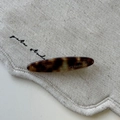 Detail of tortoise shell hair clip featuring France Handmade gold engraving on fabric - Oval Hair Clip