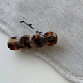Detailed macro view of an amber acetate hair clip with vintage tortoiseshell texture - Round Hair Clip
