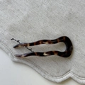 Close-up of tortoise shell pattern acetate U-shaped hair pin on linen fabric - Hair Stick