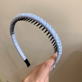 Close-up of light blue woven non-slip headband with dense inner teeth for hair grip - Blue