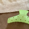 Detail of light green jelly resin hair claw clip with yellow rhinestones on brown cloth - Fluorescent Green