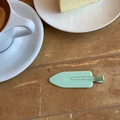 Detail of mint green matte hair clip on a marble table next to a coffee cup - Mint Green