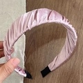 Close-up of pink pleated satin headband featuring cloud-like texture and fabric end tips - Pink
