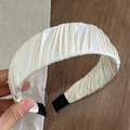 Detail of ivory satin pleated headband showing smooth glossy fabric and handmade texture - Off White