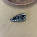 Detail view of acetate hair clip with marble pattern and colorful inlaid rhinestones - Black