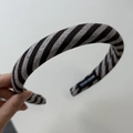 Detailed macro view of the 'Hand Made' label inside a striped fabric headband - Narrow Headband / Black